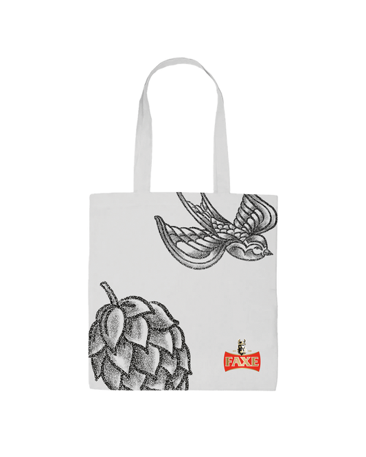 White tote bag with big printed hop and sparrow tattoo icons and FAXE Beer logo